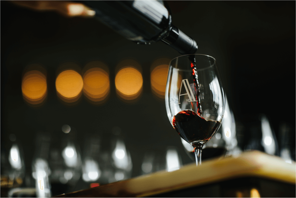 Red wine being poured into a Domaine A glasses