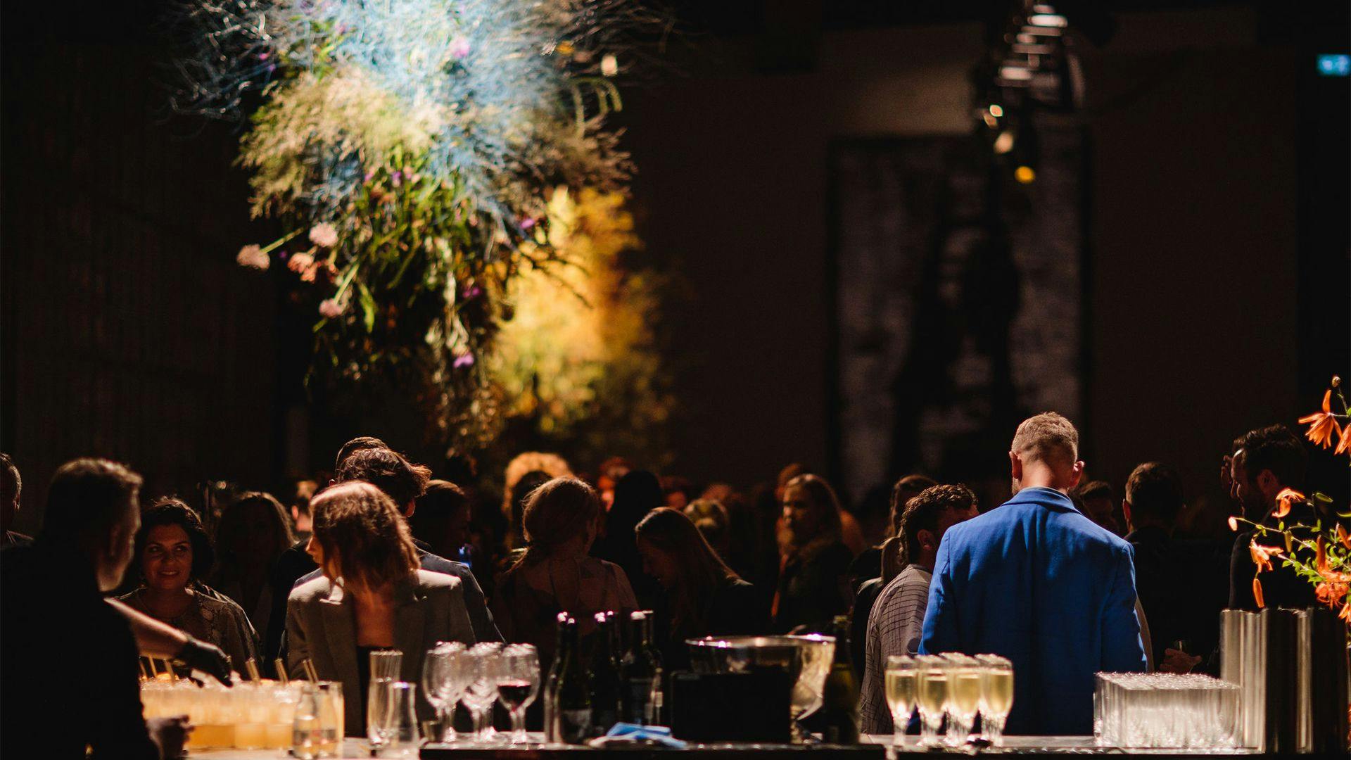 View of a crowd of people from behind the bar