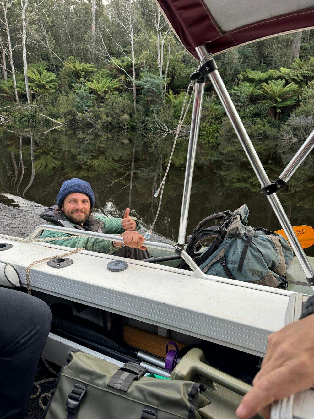 Photo of a person in an inflatable canoe on a river