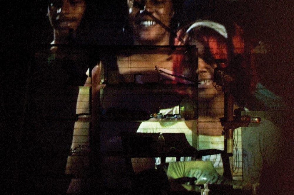 Faces projected onto a wall and chair