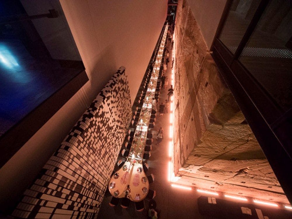 A view of the reception dinner table from B1 level walkway of the museum. It runs down the entire length of the void.